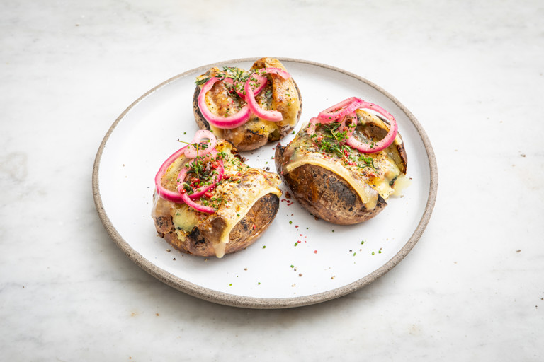 Pancetta and spinach jacket potatoes with torched raclette
