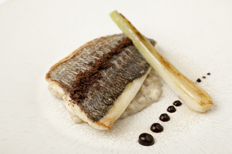 Grey mullet with pearl barley pudding, black garlic and spring onion
