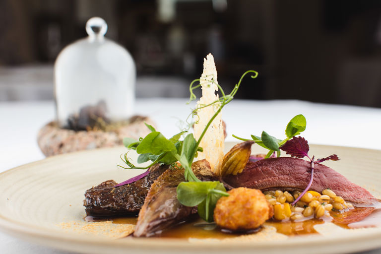 Squab pigeon, pearl barley and truffle risotto, foie gras, hay smoked offal brochette