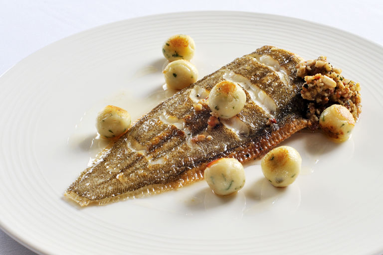 Whole Dover sole with a tarragon and lemon stuffing and potato dumplings