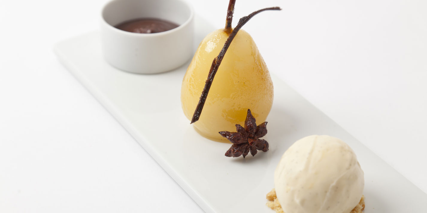 Spiced poached pears with hot chocolate sauce and vanilla ice cream
