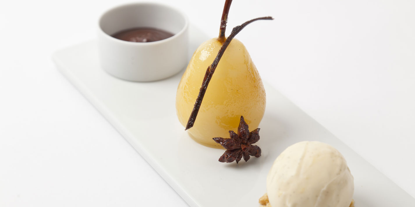 Spiced poached pears with hot chocolate sauce and vanilla ice cream