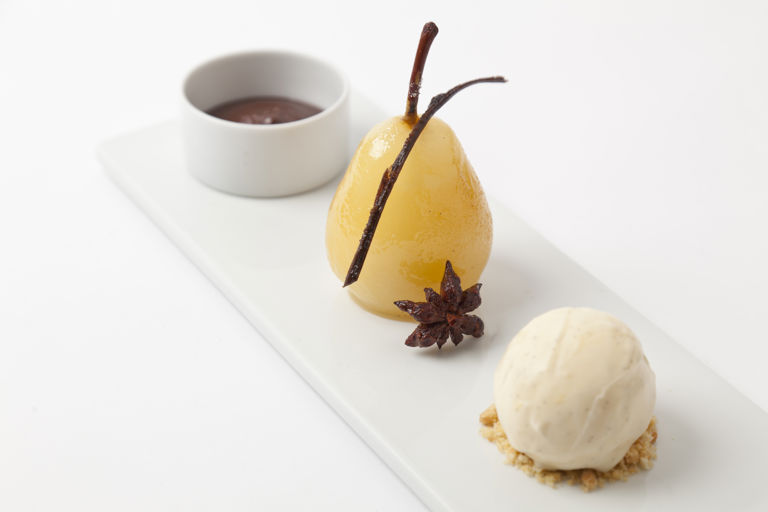Spiced poached pears with hot chocolate sauce and vanilla ice cream