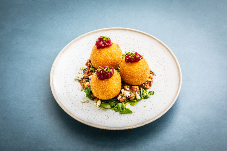 Stilton and pear arancini with cranberry ketchup and watercress