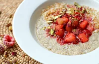 Coconut and spice quinoa porridge with apple and raspberries