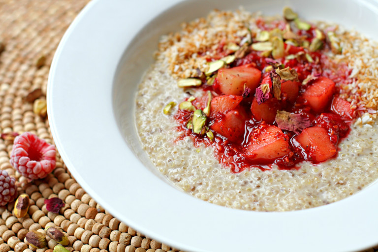 Coconut and spice quinoa porridge with apple and raspberries