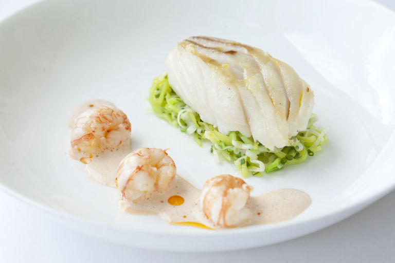 Roasted Alaska halibut with buttered leeks and langoustine bisque sauce