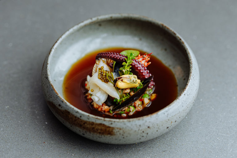 Rockpool of local seafood with sea vegetables, ginger and shellfish consommé