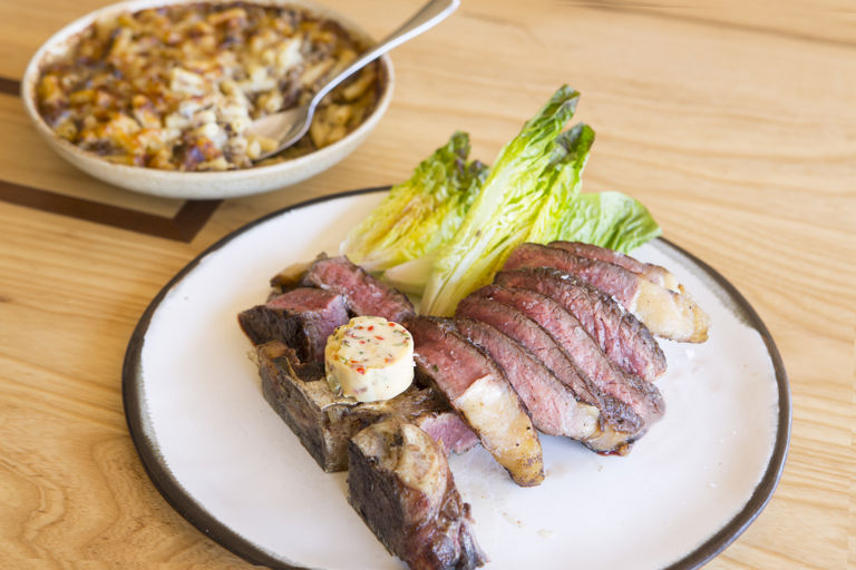 Barbecue T-bone steak with devilled butter and oxtail macaroni cheese