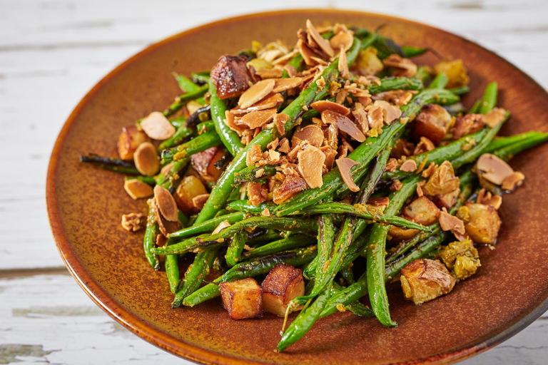Charred green beans with sauté potatoes, chermoula and fried almonds