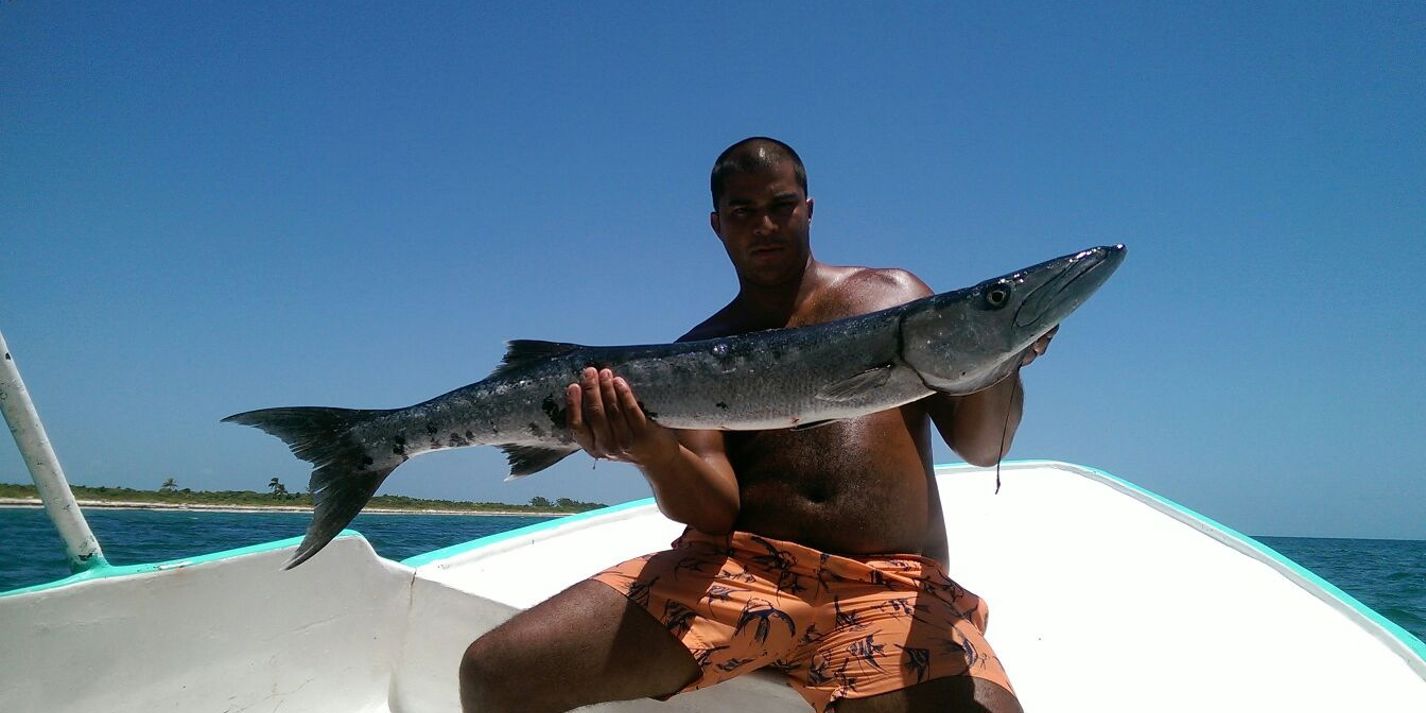 Cathing Barracuda Fish Fisherman In Sport Fishing Boat Holding Big