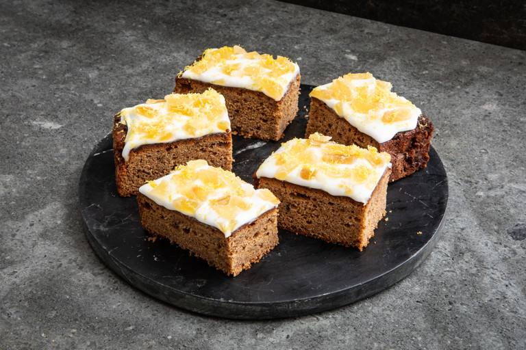 Lemon drizzle, treacle and ginger traybake with candied ginger stem icing 