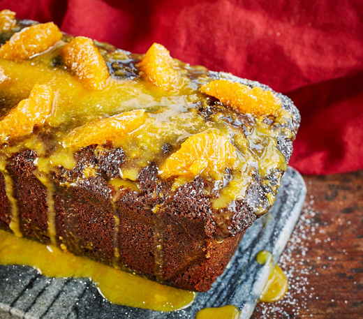 Spelt, ginger and treacle loaf with clementine icing