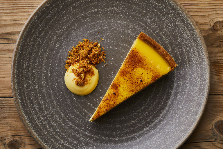 Passion fruit tart, lemon curd sauce and hazelnut praline