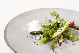Asparagus with Parmesan snow, olive biscuit and hazelnuts