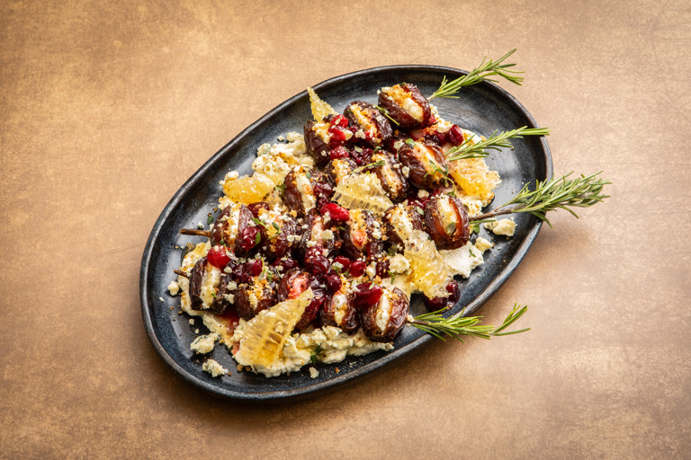 Stilton-stuffed medjool dates with cranberry syrup and rosemary skewers