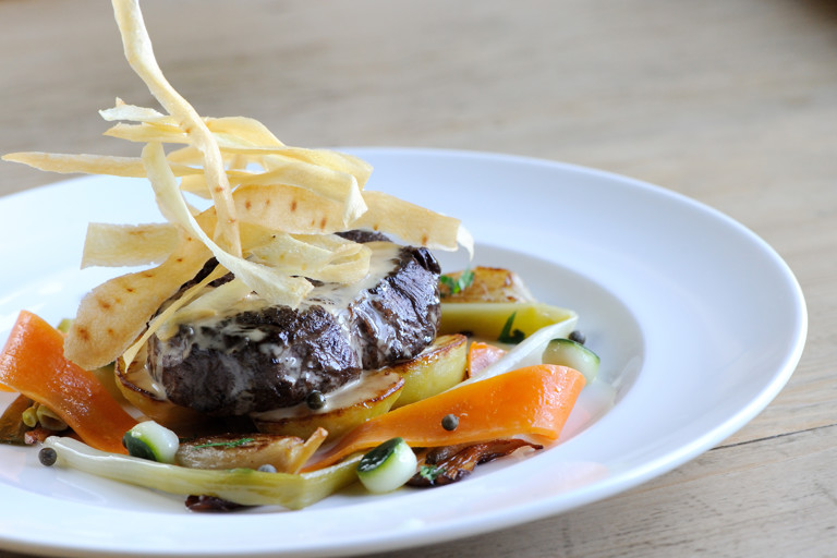 Beef fillet with roasted shallots, sauté potatoes and green peppercorn sauce