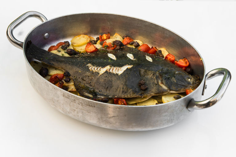 Flounder with potatoes, tomatoes, olives and capers