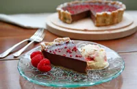 Dark chocolate and hazelnut tart with raspberry, pink peppercorn and crushed meringue ice cream 