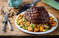 Roast gammon with sweet potato roasties and bacon sprouts