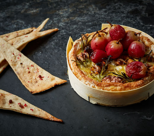 Baked camembert with roasted grapes, walnuts, rosemary and pink peppercorn crackers