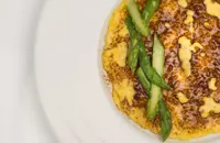 Risotto with egg yolk, liquorice powder and green asparagus