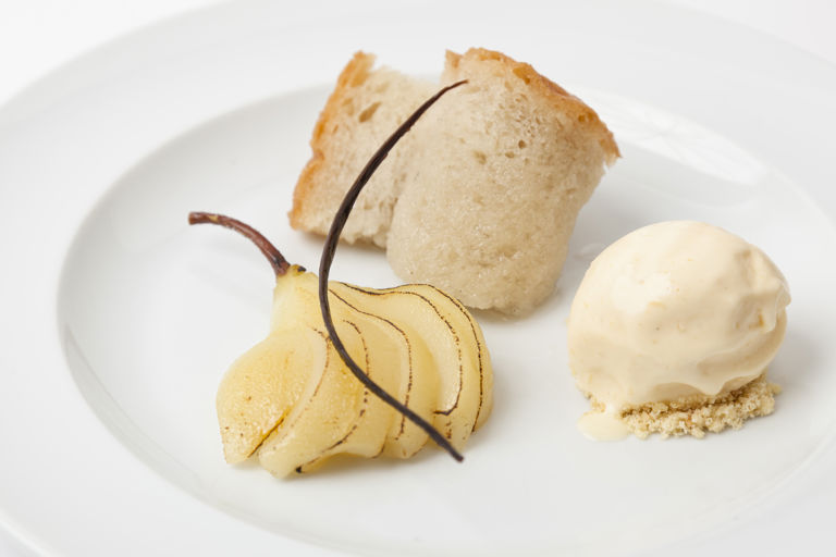 Rum baba with spiced, poached pears and ginger ice cream