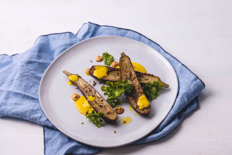 Spiced aubergine with turmeric and coconut sauce, cashew butter and crispy kale