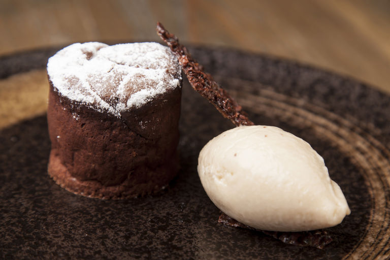 Hot chocolate fondant with brakspear black stout ice cream and cocoa nibs