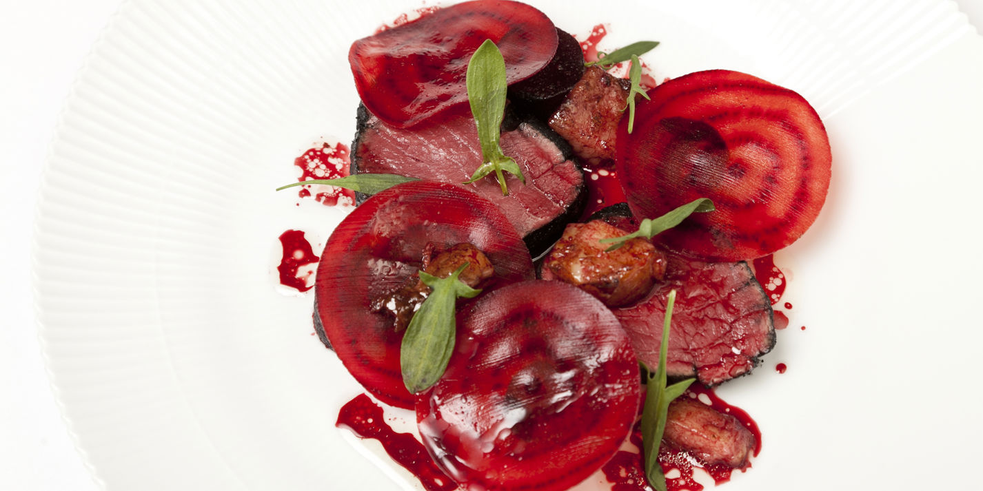 Beef fillet in burnt hay with smoked bone marrow, salt baked and raw beetroot