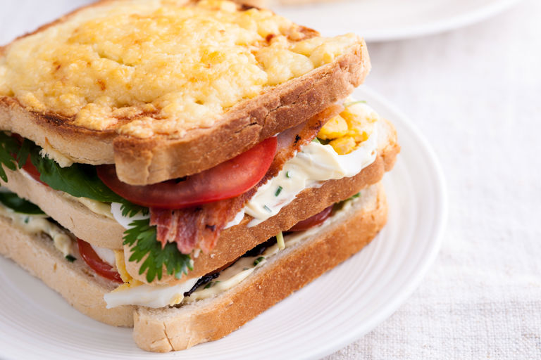Bacon, egg, tomato and cheddar-garlic mayo club sandwich