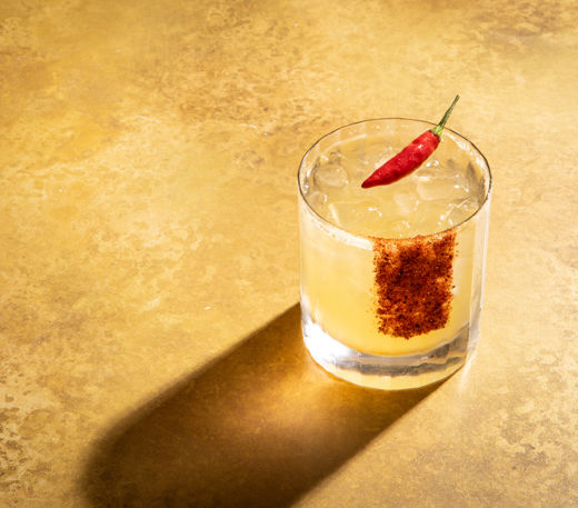 Pineapple and lime rum punch with spiced citrus sugar