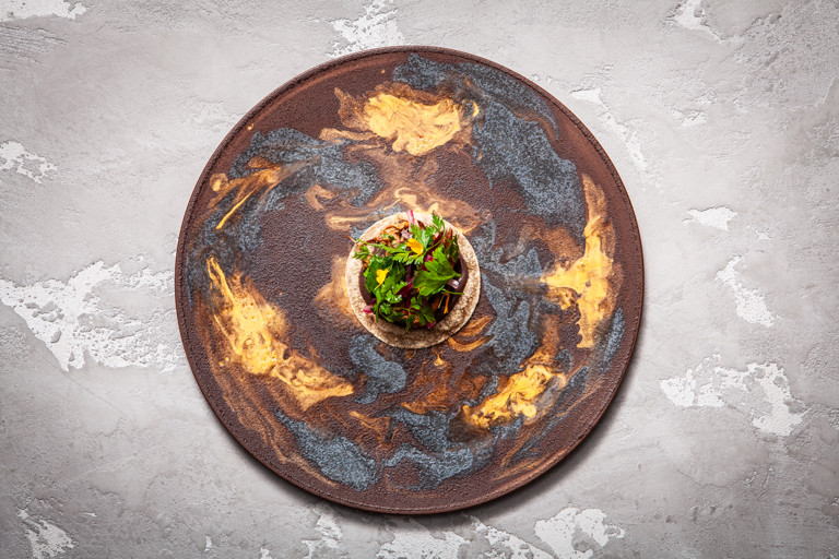 Churrasco (barbecued) lamb breast, black bean feijoada and cassava tacos