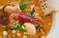 Seafood soup with fregula, basil and citrus