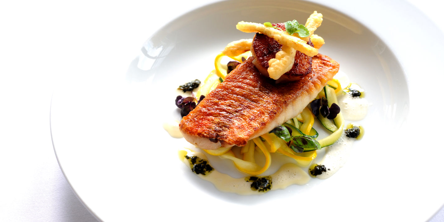 Pan-fried red mullet on courgette tagliatelle with scallops and purple basil pesto