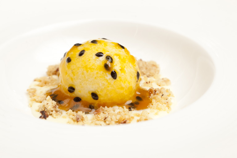 Banana and rum ice cream with passion fruit, walnuts, white chocolate sauce