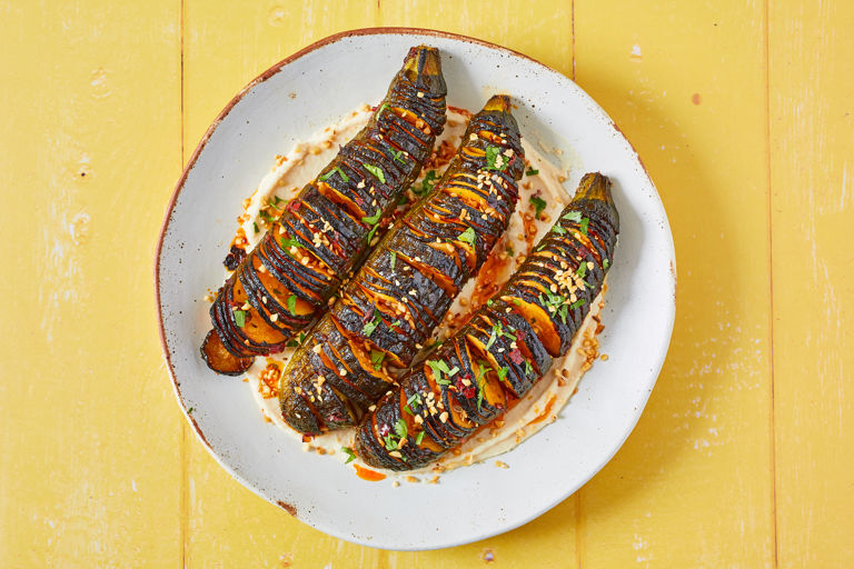 Harissa hasselback courgettes with butterbean and tahini dip and dukkah