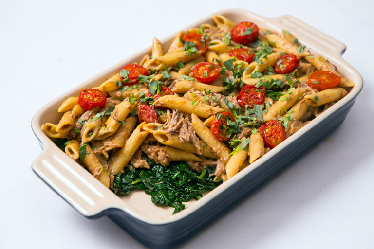 Confit duck leg with penne, spinach and tomato