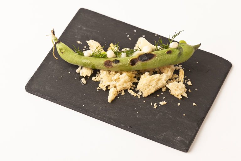 Charred broad beans with St. Jorge cheese and brioche crumbs