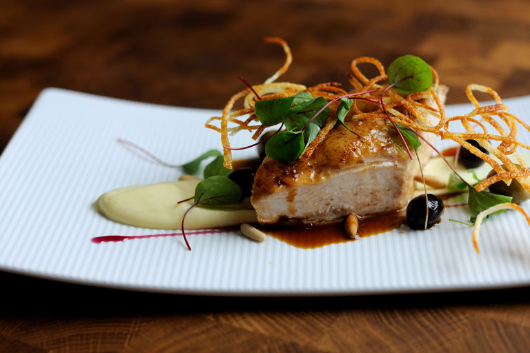Roast chicken breast, potato purée and pine nuts