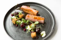Roast duck breast and crispy leg croquettes with cherries and almonds