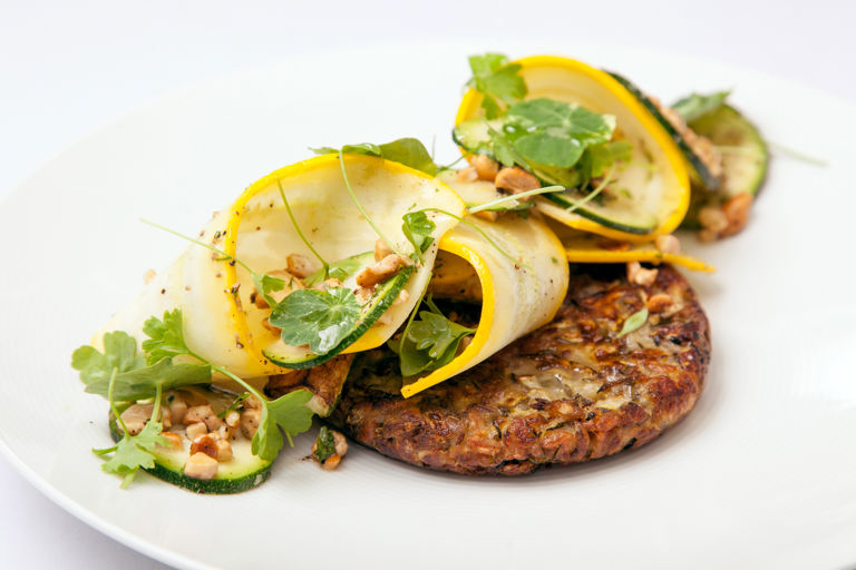 Courgette, spelt and cumin fritters, courgette, parsley and cashew salad