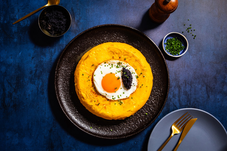 Caviar-topped Spanish tortilla topped with a crispy fried egg