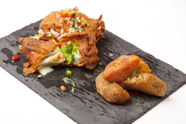 Amritsar-spiced Alaska halibut with mustard mushy peas, caper kachumber and tandoori potato wedges