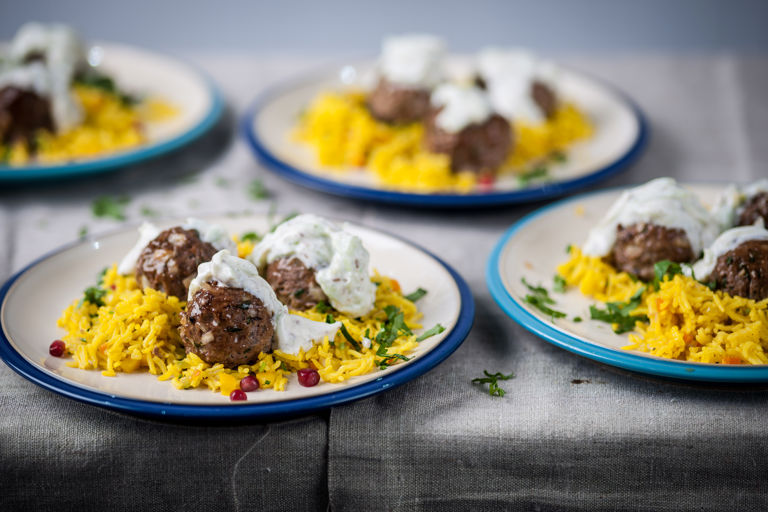 Spicy lamb balls with jewelled rice and cumin yoghurt