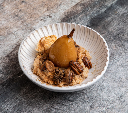 Rice pudding with rum poached pears, cinnamon and caramelised pecans