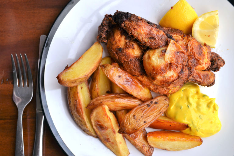 Deep-fried poussin with tarragon mayonnaise and potato wedges
