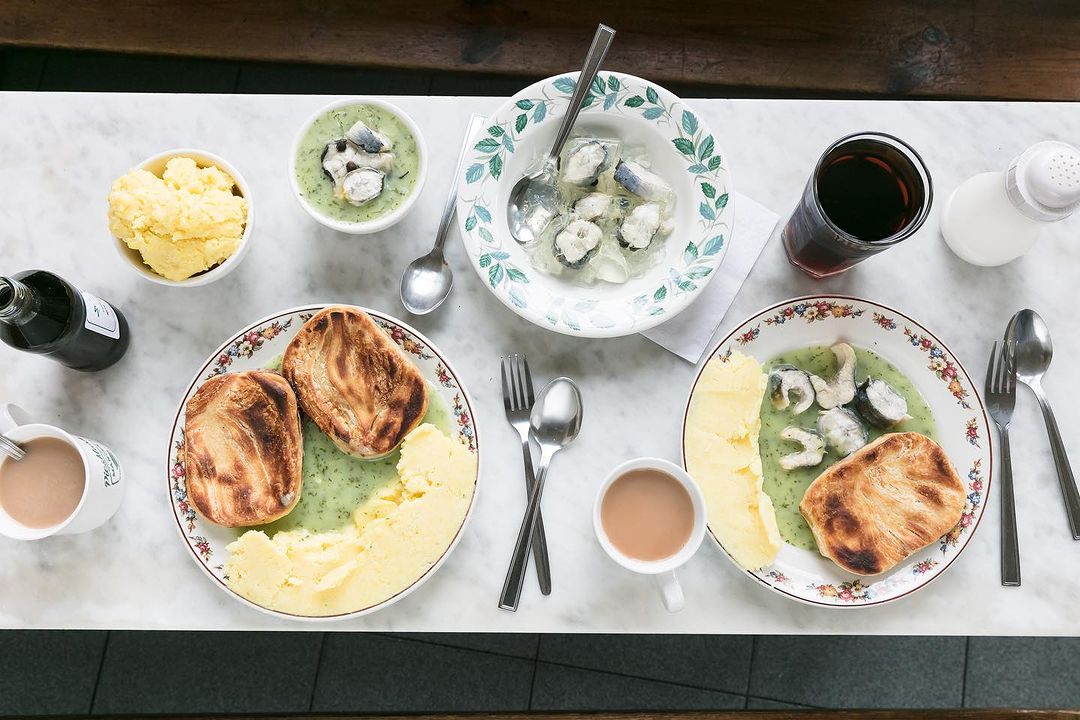 A table of pie, mash and liquor from M Manze in London
