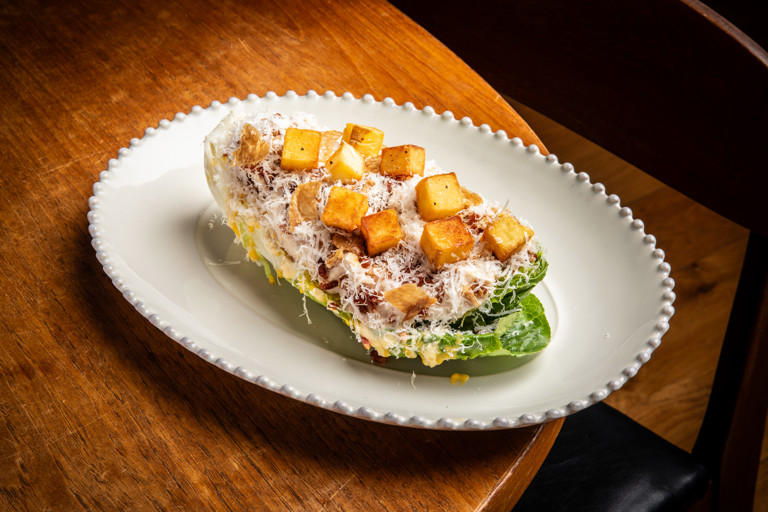 Chicken Caesar salad with chip croutons and confit egg yolk