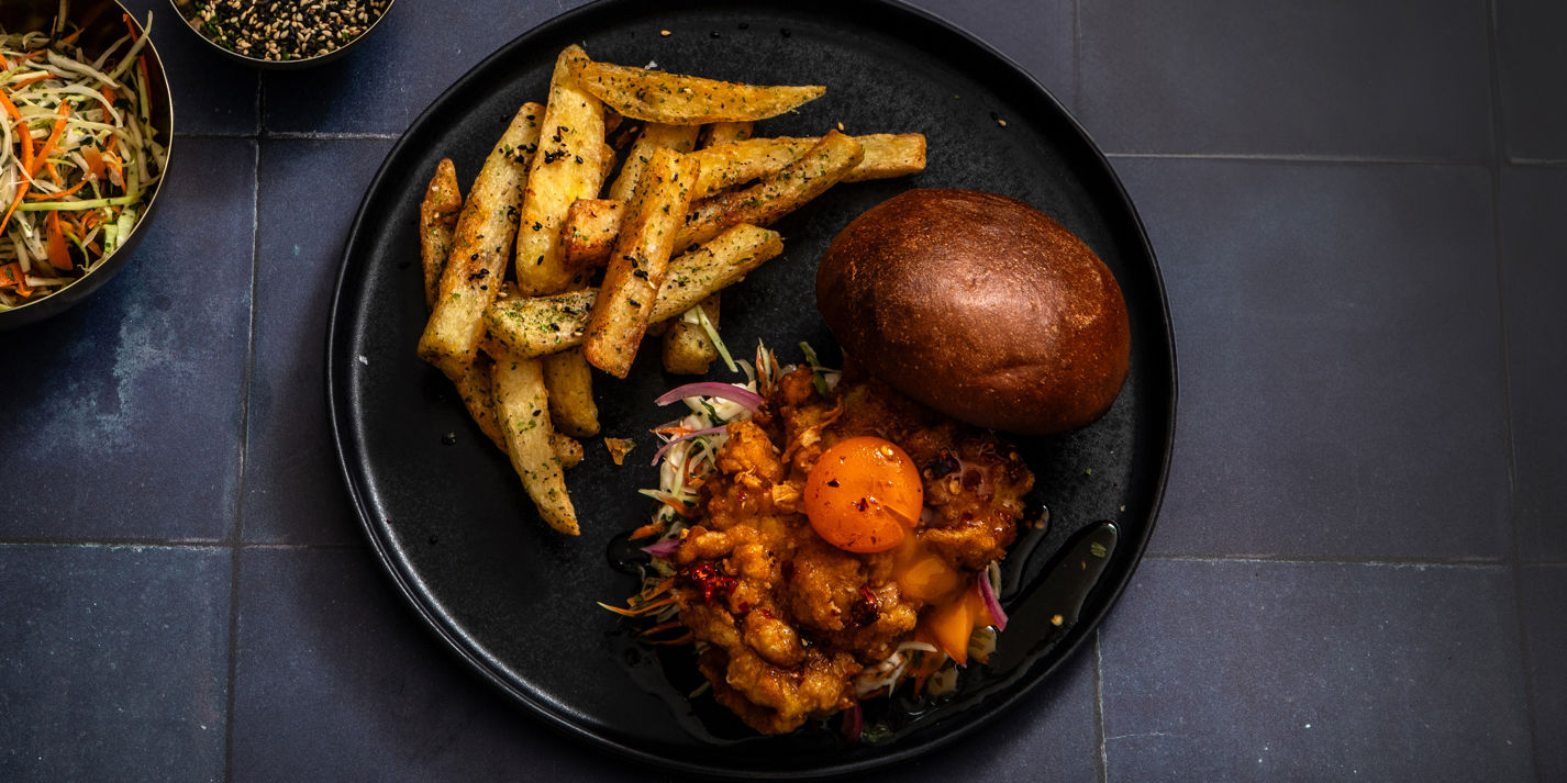 Buttermilk fried chicken sandwich with hot honey cured egg yolk and furikake chips - Great British C